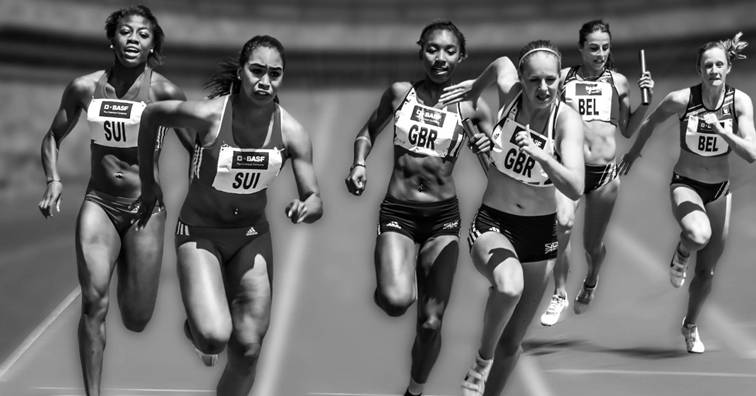 Vrouwenteams uit Zwitserland, Groot-Brittannië en België in actie tijdens een estafetteloop op de atletiekbaan